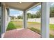 View of the covered patio area and a spacious backyard with a white fence at 4713 Jasmine Cir, Leesburg, FL 34748