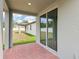 Covered patio with sliding glass doors and view of the spacious backyard at 4713 Jasmine Cir, Leesburg, FL 34748