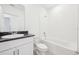 Well-lit bathroom with white vanity, bathtub, and tile at 4717 Jasmine Cir, Leesburg, FL 34748