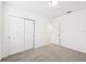 Cozy bedroom boasts ample closet space with double doors and neutral-colored carpeting at 4717 Jasmine Cir, Leesburg, FL 34748