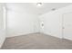 Well-lit bedroom featuring plush carpeting and two entryways at 4717 Jasmine Cir, Leesburg, FL 34748