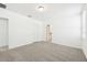 Spacious carpeted bedroom with two entryways and a bright window at 4717 Jasmine Cir, Leesburg, FL 34748