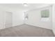 Carpeted bedroom with two windows and an attached bathroom at 4717 Jasmine Cir, Leesburg, FL 34748