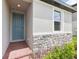 Close up shot of the front entryway with brick pavers and a blue front door at 4717 Jasmine Cir, Leesburg, FL 34748