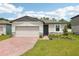Charming single-story home featuring a brick driveway, attached garage and well manicured landscaping at 4717 Jasmine Cir, Leesburg, FL 34748