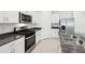 Modern kitchen featuring stainless steel appliances, a gas range, and white cabinetry at 4717 Jasmine Cir, Leesburg, FL 34748