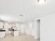 Open-concept living space with tile flooring, kitchen island and modern appliances at 4717 Jasmine Cir, Leesburg, FL 34748