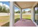 The covered patio features brick flooring with views of the grassy backyard with privacy fence at 4717 Jasmine Cir, Leesburg, FL 34748