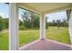 This back porch leads to the grassy backyard at 4728 Jasmine Cir, Leesburg, FL 34748