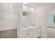 Bathroom with dual sinks, mirrors, and a walk-in closet on the left side at 4728 Jasmine Cir, Leesburg, FL 34748