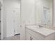 Bright bathroom features a white vanity with a modern sink and faucet at 4728 Jasmine Cir, Leesburg, FL 34748