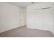 Bedroom with carpet, closet, and open door to another room at 4728 Jasmine Cir, Leesburg, FL 34748