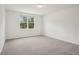 Bright bedroom with neutral carpet, a large window, and white walls at 4728 Jasmine Cir, Leesburg, FL 34748