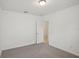 This bedroom offers neutral walls and soft carpet with a doorway leading to another room at 4728 Jasmine Cir, Leesburg, FL 34748