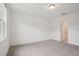 A well-lit bedroom with neutral carpet, white walls, and a view from the window at 4728 Jasmine Cir, Leesburg, FL 34748