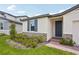Charming home exterior with blue door and shutters, stone accents, and well-maintained landscaping at 4728 Jasmine Cir, Leesburg, FL 34748