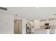 Open concept living space showcasing a modern kitchen with stainless steel appliances and white cabinetry at 4728 Jasmine Cir, Leesburg, FL 34748