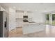 Modern kitchen with stainless steel appliances, white cabinets, and a view of the backyard at 4728 Jasmine Cir, Leesburg, FL 34748