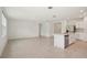 Open concept living room with tile flooring next to a modern kitchen with island at 4728 Jasmine Cir, Leesburg, FL 34748
