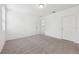 Comfortable carpeted bedroom with a door leading to another room, offering flexibility at 4732 Jasmine Cir, Leesburg, FL 34748