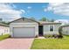 Charming one-story home with a two-car garage, brick driveway and a beautifully landscaped front yard at 4732 Jasmine Cir, Leesburg, FL 34748