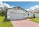 The house is a one story home with a two-car garage and a red brick driveway at 4732 Jasmine Cir, Leesburg, FL 34748