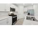 Modern kitchen with white cabinets, stainless steel appliances, and an island perfect for cooking and entertaining at 4732 Jasmine Cir, Leesburg, FL 34748