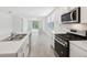Modern kitchen with stainless steel appliances offers an open layout perfect for entertaining friends and Gathering at 4732 Jasmine Cir, Leesburg, FL 34748
