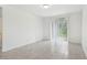 Living room with tile floors, a sliding glass door to the backyard, and neutral walls at 4732 Jasmine Cir, Leesburg, FL 34748