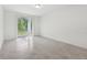 A living room with tile floors and sliding doors that leads to the backyard at 4732 Jasmine Cir, Leesburg, FL 34748