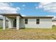 Exterior rear view of the home with covered patio at 4732 Jasmine Cir, Leesburg, FL 34748