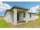 Rear exterior featuring a covered patio and sliding glass door at 4732 Jasmine Cir, Leesburg, FL 34748