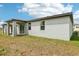 Exterior side and rear of house with covered patio at 4732 Jasmine Cir, Leesburg, FL 34748