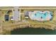 Aerial view of a community pool, playground, and gathering area with lake views at 4981 Kaia Ave, Winter Haven, FL 33884