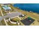 Aerial view of community amenities featuring a playground, community pool, and scenic lake at 4981 Kaia Ave, Winter Haven, FL 33884