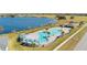 Aerial view of a community pool, lounge chairs, and a scenic lake backdrop at 4981 Kaia Ave, Winter Haven, FL 33884