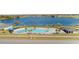 Aerial view of a community pool with a backdrop of lake views at 4981 Kaia Ave, Winter Haven, FL 33884
