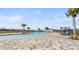 Community pool featuring palm trees, lounge chairs, and a paved deck area at 4981 Kaia Ave, Winter Haven, FL 33884