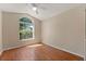 Bedroom with light wood floors, large arched window offering lots of natural light at 5537 Misty Woods Dr, Oviedo, FL 32765
