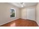 Bedroom features wood floors, double closet, and a bright window view at 5537 Misty Woods Dr, Oviedo, FL 32765