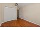 Bedroom with wood floors, closet, and ensuite access at 5537 Misty Woods Dr, Oviedo, FL 32765