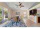 This dining room has a ceiling fan, neutral colors, tile floor and a nice view of the yard at 5537 Misty Woods Dr, Oviedo, FL 32765