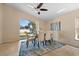 This dining room has a ceiling fan, neutral colors, tile floor and a nice view of the yard at 5537 Misty Woods Dr, Oviedo, FL 32765