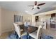 This dining room has a ceiling fan, neutral colors, tile floor and a nice view of the kitchen at 5537 Misty Woods Dr, Oviedo, FL 32765