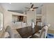 This dining room features a modern ceiling fan and a rustic wood table for six at 5537 Misty Woods Dr, Oviedo, FL 32765