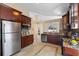 This kitchen has granite countertops, tile floors, stainless steel appliances and dark wood cabinets at 5537 Misty Woods Dr, Oviedo, FL 32765
