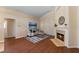 Inviting living room with hardwood floors, a fireplace, and contemporary decor at 5537 Misty Woods Dr, Oviedo, FL 32765