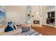 Comfortable living room featuring a fireplace, hardwood floors, and easy access to other rooms at 5537 Misty Woods Dr, Oviedo, FL 32765