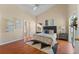 Spacious main bedroom featuring wood floors, neutral paint, and ensuite bathroom at 5537 Misty Woods Dr, Oviedo, FL 32765