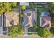 Aerial view of a home featuring a screened-in pool, solar panels, and a well-manicured yard with mature landscaping at 600 Rob Roy Dr, Clermont, FL 34711